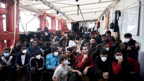 Migrants sit aboard the Ocean Viking rescue ship