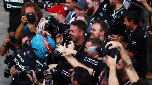 Russell is mobbed by his pit crew