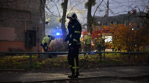 Ukrainian firefighters at the scene where a Russian missile fragment fell near a residential building in the centre of Kyiv