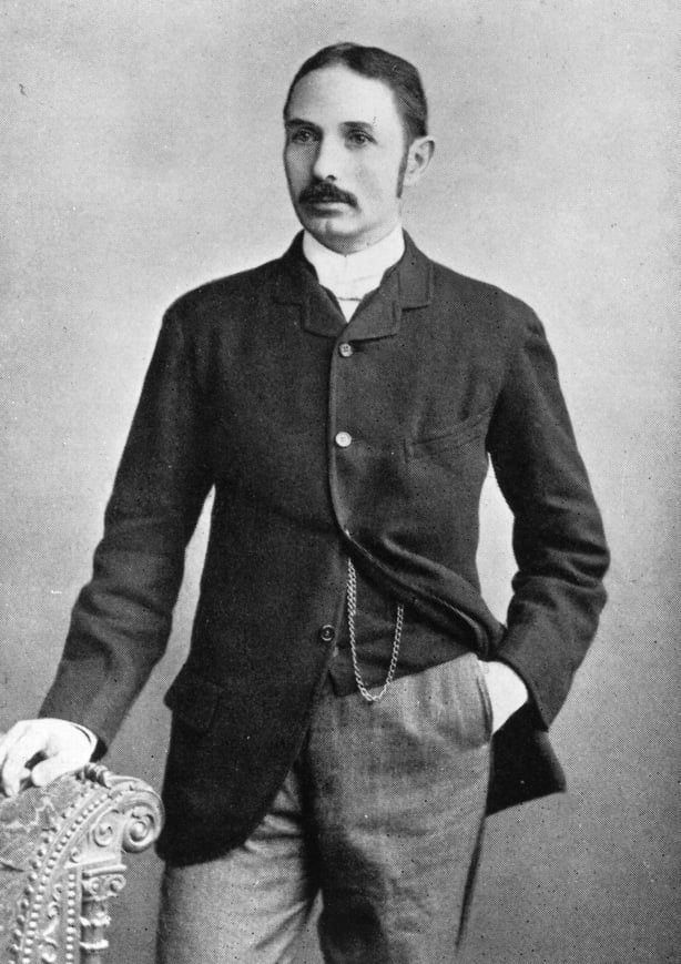 A black and white photograph of a young victorian gentleman with dark hair and a moustache