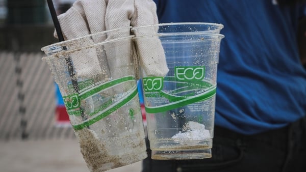 Greenwashed up: plastic cups with green messaging found on a beach cleanup. Photo: Brian Yurasits/Unsplash