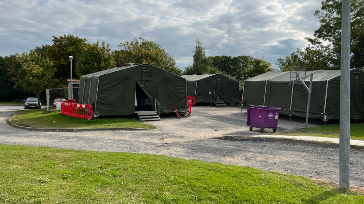 Refugees back in tented accommodation