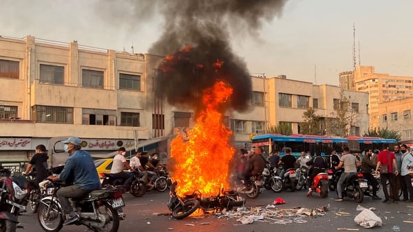 A burning motorcycle during a protest in October