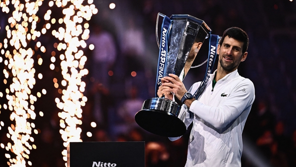 Novak Djokovic poses with the winner's trophy