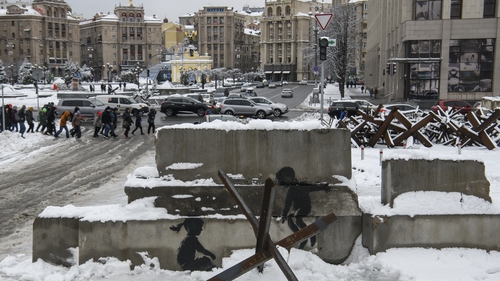 Graffiti said to be by the artist Banksy is seen on concrete blocks in Kyiv's Independence Square