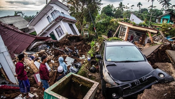 Villagers in Cianjur salvage items from damaged houses following a 5.6-magnitude earthquake