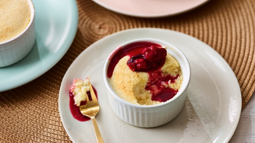 Individual sweet souffles with fruity sauce make for a decadent dessert.