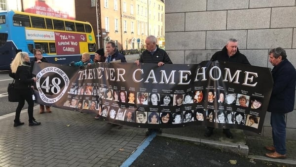 Families of those killed in the 1981 Stardust nightclub tragedy carry a banner held by Antoinette Keegan, former RTÉ correspondent Charlie Bird and others