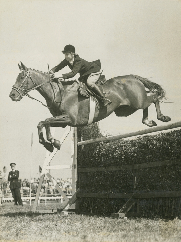 Black and white photo of Iris Kellett and her champion horse Rusty leaping over a jump