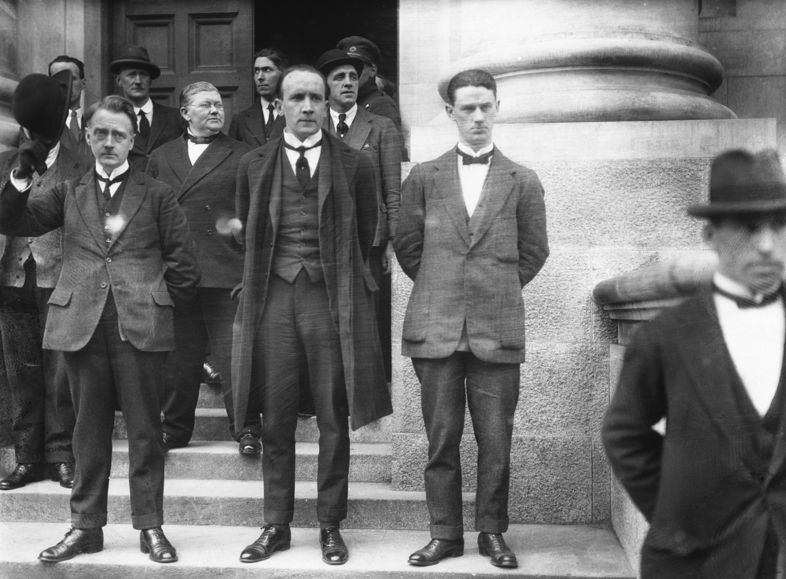 Image - William T Cosgrave with Kevin O'Higgins, Minister for Justice, taking the salute from National Army soldiers outside Government Buildings. Photo © RTÉ Photographic Archive