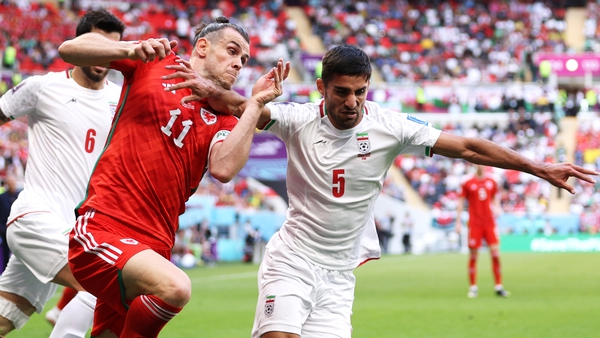 Milad Mohammadi of Iran holds off Gareth Bale