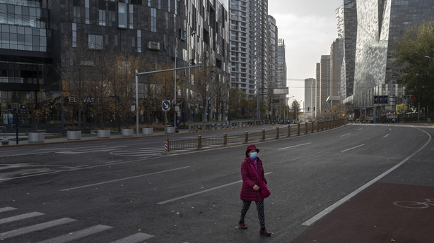 Woman walks on a deserted street in Beijing