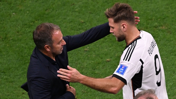 Niclas Fullkrug (R) celebrates with Germany's coach Hans-Dieter Flick after scoring against Spain