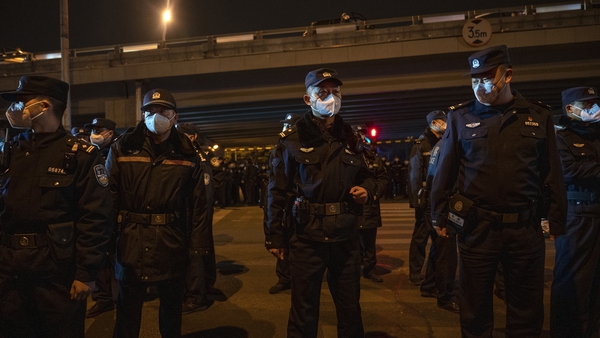 Police form a cordon during a protest in Beijing