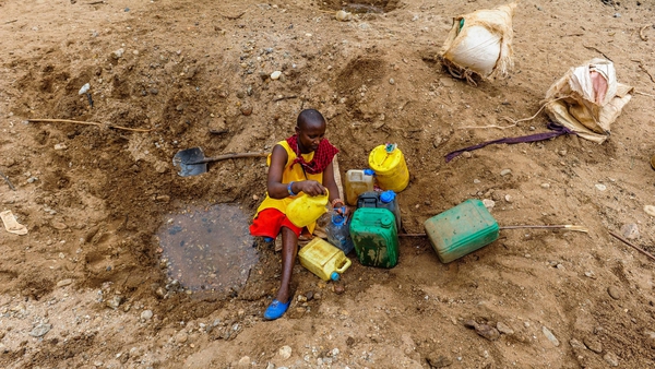 A girl tries to get clean water in Kenya's Rift Valley province