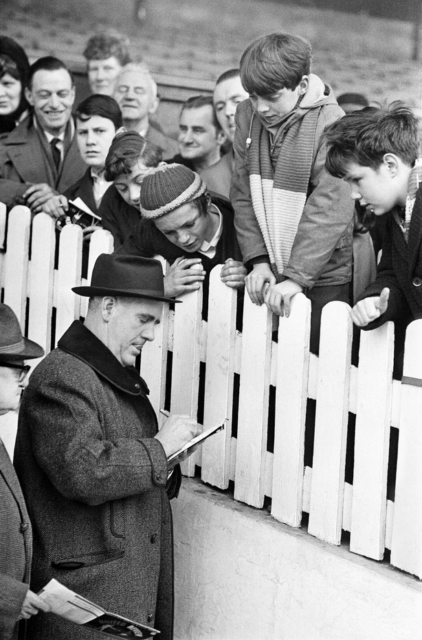 Johnny Carey signing autographs for young fans