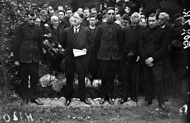 Black and white photo of Cosgrave at the side of Collins's grave