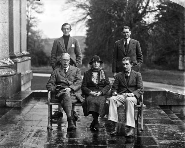 A group of aristocrats on the terrace of a big house in 1920s clothes