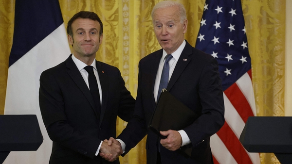 US President Joe Biden and French President Emmanuel Macron shake hands after a joint press conference in the White House