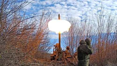 Armed members of the self-proclaimed Donetsk People's Republic fire howitzer on the Bakhmut border front in Donetsk