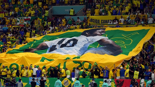 Brazil fans unfurl a banner of the legendary Pele