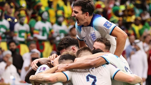 Harry Maguire (top) celebrating with his England team-mates after Harry Kane scored against Senegal
