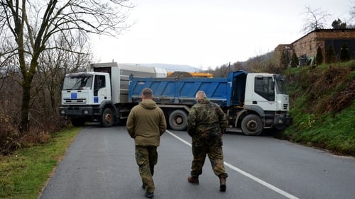 German officers serving in the peacekeeping mission in Kosovo inspect a road barricade in the village of Rudare near the town of Zvecan
