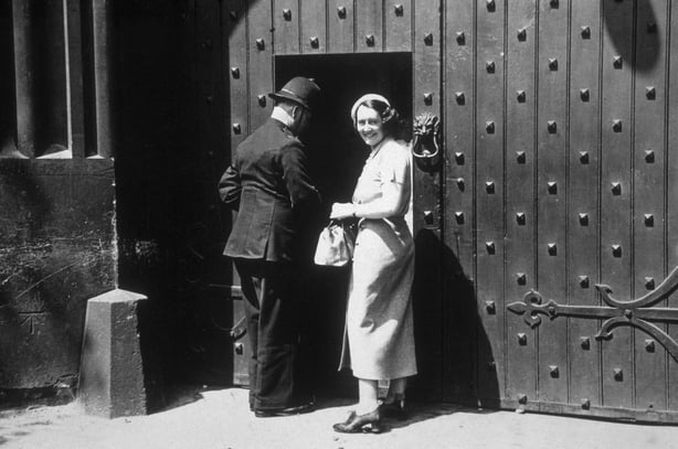 Fay Taylour smiling at the gates of Holloway prison