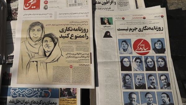A local paper in Tehran carries a headline criticising the detention of two of its reporters, who helped publicise the case of Mahsa Amini