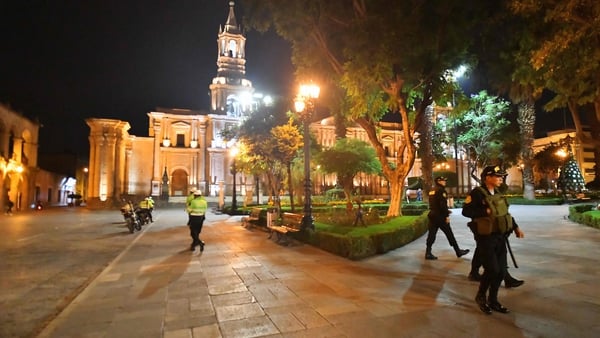 Members of the police patrol the streets during a curfew in the province of Arequipa, Peru