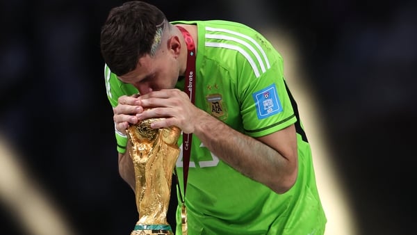 Emiliano Martinez kisses the iconic trophy after Argentina won the World Cup
