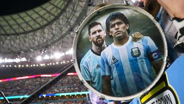 Argentina supporters show their support with a drum adorned with the images of Diego Maradona and Lionel Messi