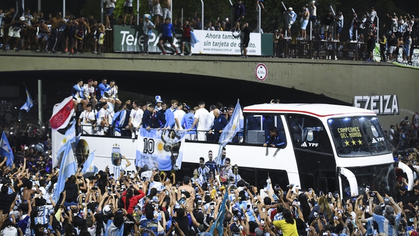 The Argentinian team make their way through Buenos Aires on an open top bus