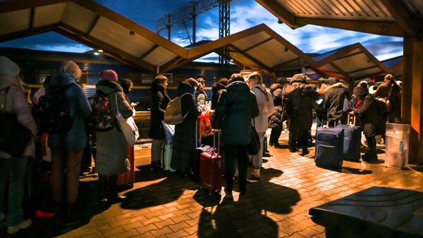 Ukrainians standing in line at passport control after arriving on the evening train from Ukraine to Przemysl in Poland