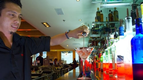 A bartender prepares a drink at a cocktail bar at the Mall of the Emirates in Dubai