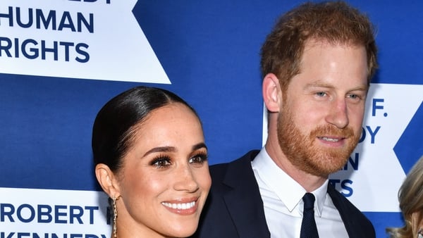 Prince Harry pictured right with wife Meghan Markle