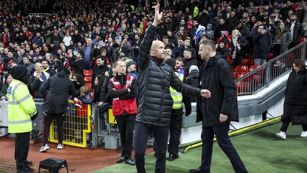 Manchester United's manager waves to supporters