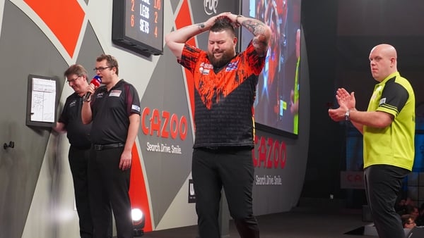 Michael Smith is overcome with emotion after becoming world champion and world number one at Alexandra Palace
