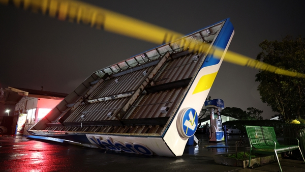 A damaged gas station creaks in the wind during a massive 'bomb cyclone' rain storm in South San Francisco, California