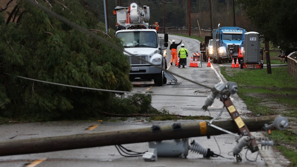 Utility workers prepare to make repairs to downed power lines on Nicasio Valley Road
