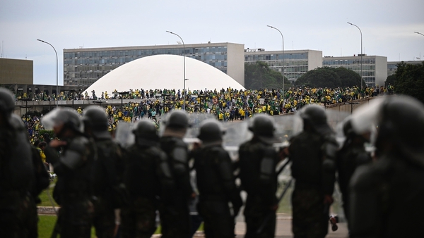 Security forces face supporters of former Brazilian president Jair Bolsonaro at the National Congress in Brasilia