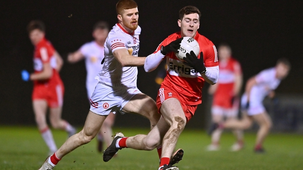 Derry's Padraig McGrogan wins possession in front of Tyrone's Cathal McShane