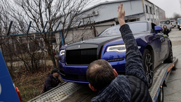 A Rolls-Royce is taken away from the Tate compound in Romania