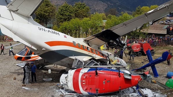 A Summit Air Let L-410 Turbolet aircraft (L) hit two helicopters at Lukla airport in April 2019