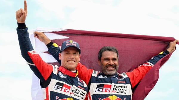 Nasser Al-Attiyah (R) and his co-driver Mathieu Baumel celebrate after winning the Dakar Rally 2023