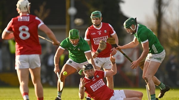 Cork's Conor Cahalane is tackled by Robbie Hanley, left, and Mark Quinlan