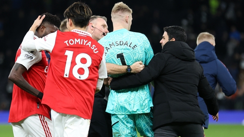 Aaron Ramsdale is ushered away from the crowd by Arsenal boss Mikel Arteta and referee Craig Pawson