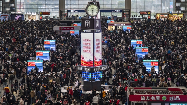 Passengers and wait for trains at the Shanghai Hongqiao Railway Station during the peak travel rush
