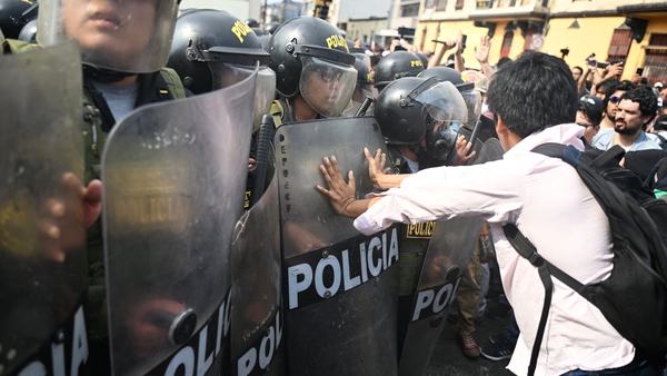 People protest outside the Police Investigation Operations Centre in Lima after protesters were arrested