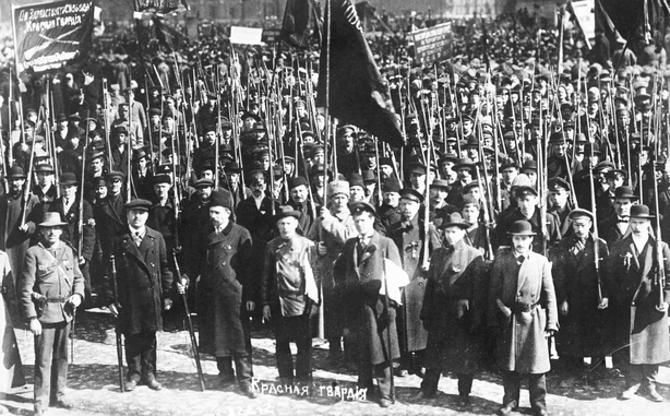 An armed group of Red Guards mass in the street near the Bolshevik headquarters in Petrograd during the Russian Civil War.